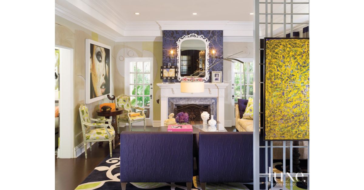 Living room with purple decor and artwork - Luxe Interiors + Design