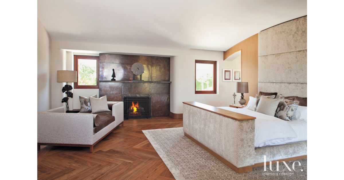 modern bronze fireplace in master suite - luxe interiors