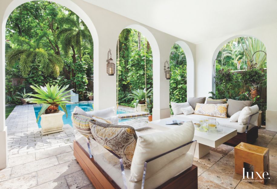 White Arched Loggia with Pool Adjacent and Glass Outdoor Seating - Luxe ...