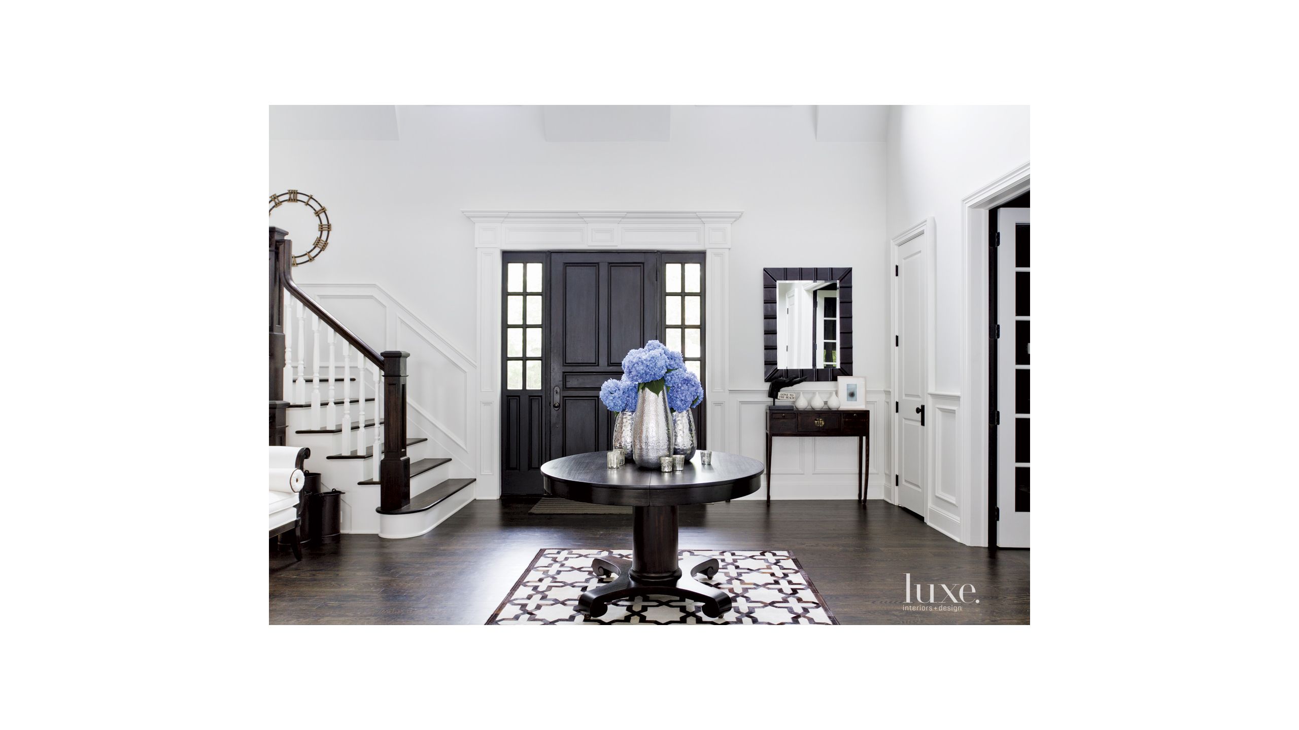 Contemporary White Foyer With Antique Center Table Luxe